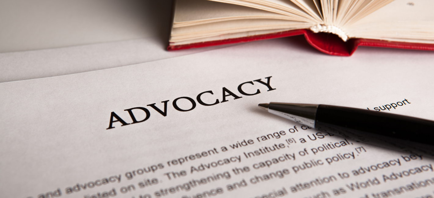 Advocacy. An image of a book and the word Advocacy printed on paper.